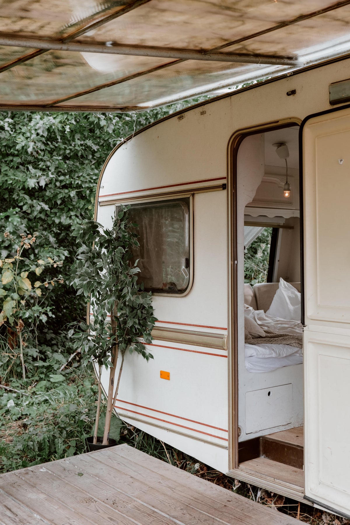 A caravan that has its door open and peeking in